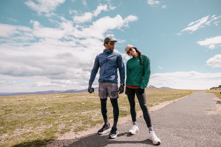 Two people standing on the road in running clothing