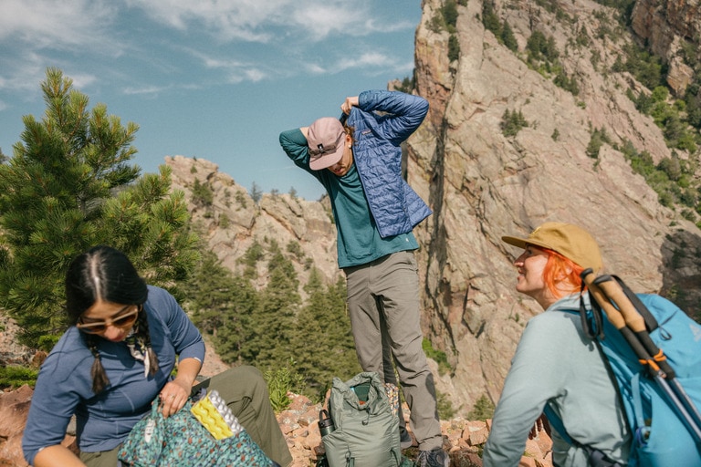 Three hikers take a break at the summit.