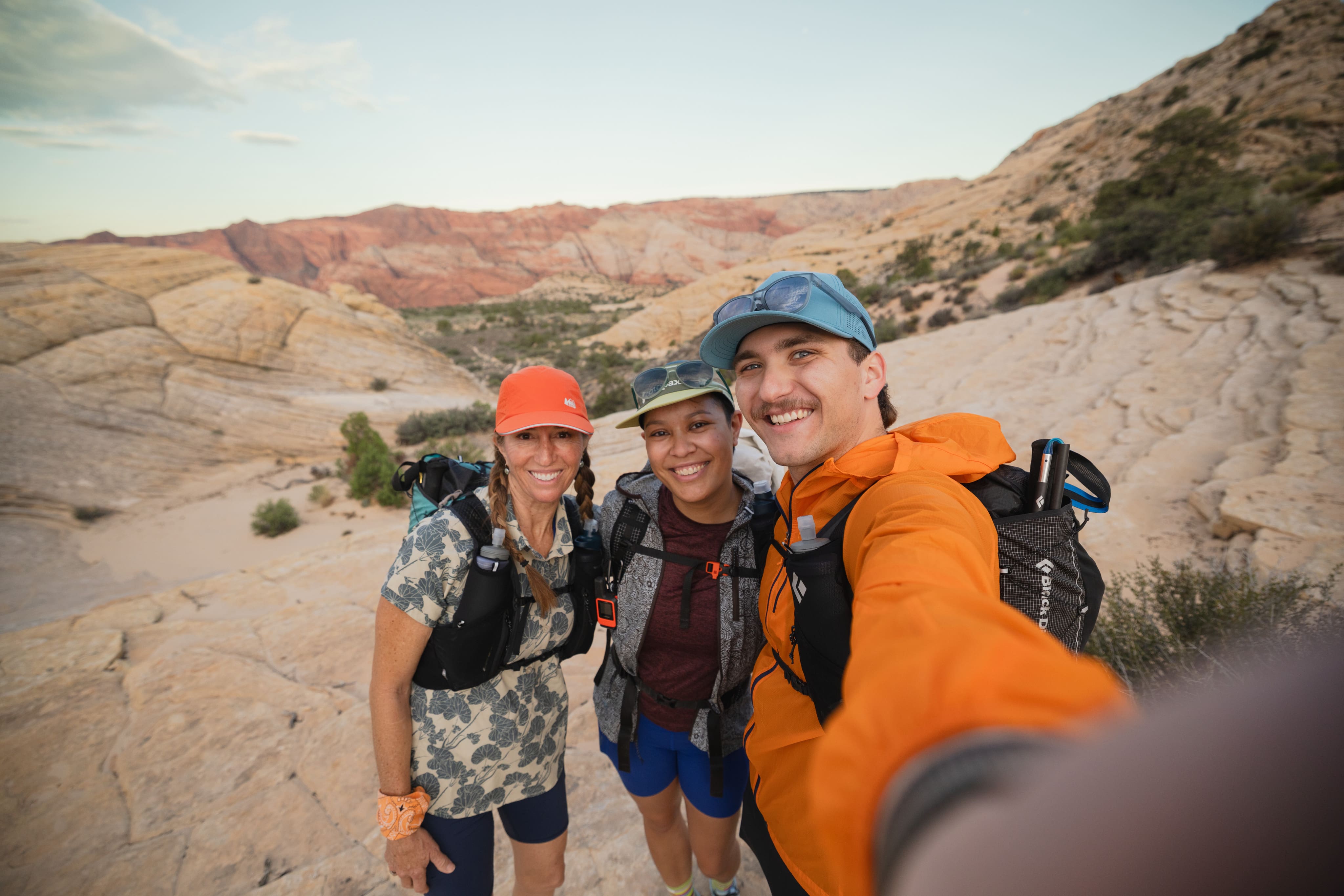 Three friends take a selfie while hiking in the desert