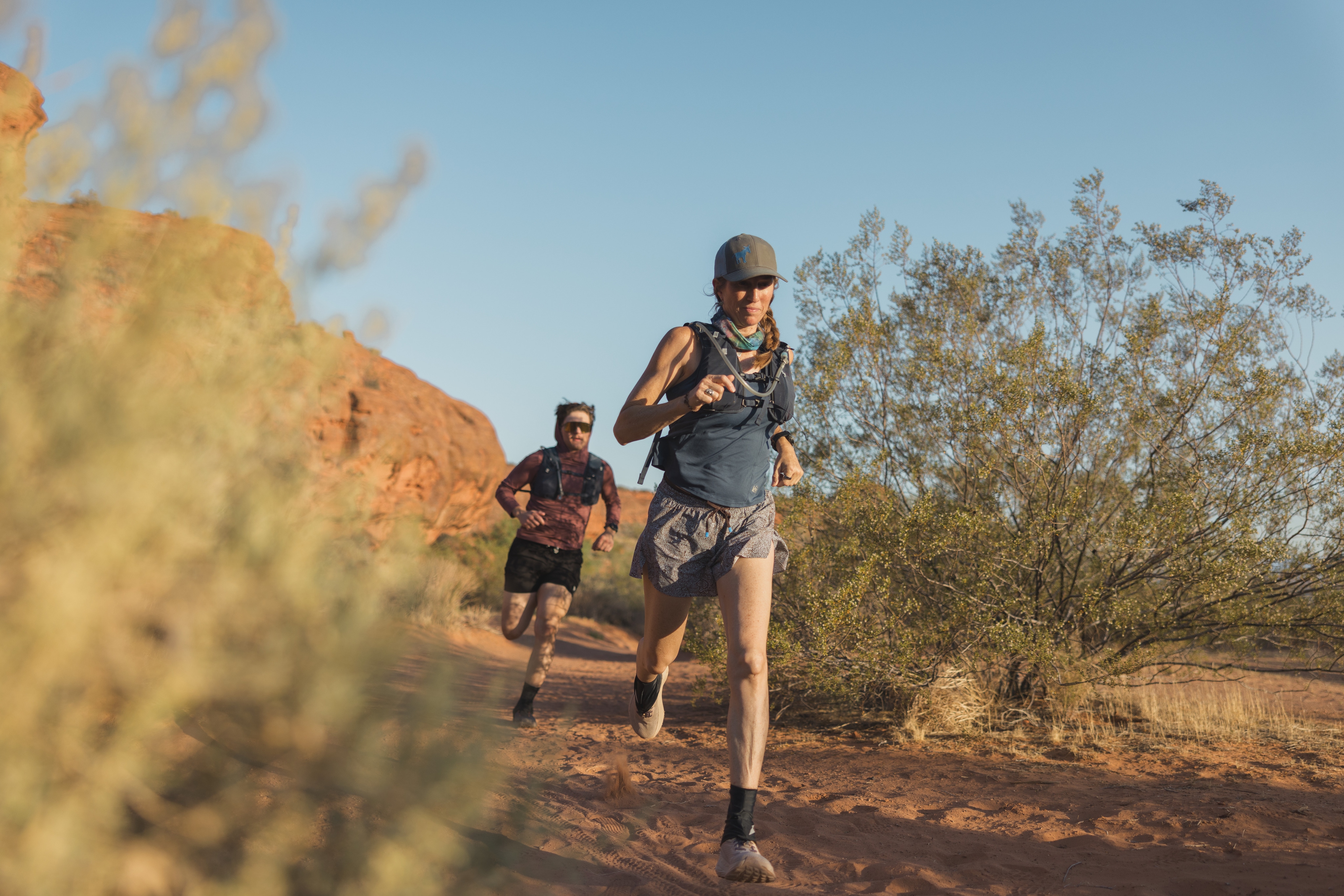 Two people run on a warm, sunny day.