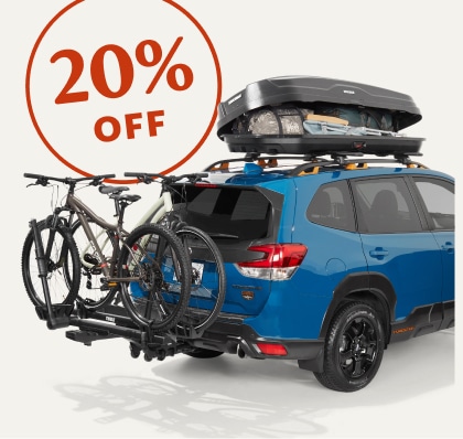 20 percent off. A blue Subaru Forester with a Yakima roof box and a Thule bike rack.