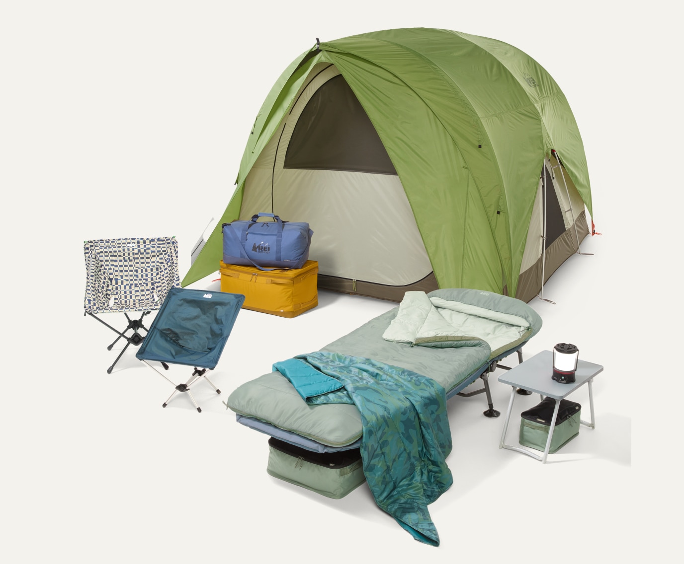 R E I Co-op brand camp gear including a tent, sleeping bag, cot, table, & chairs.