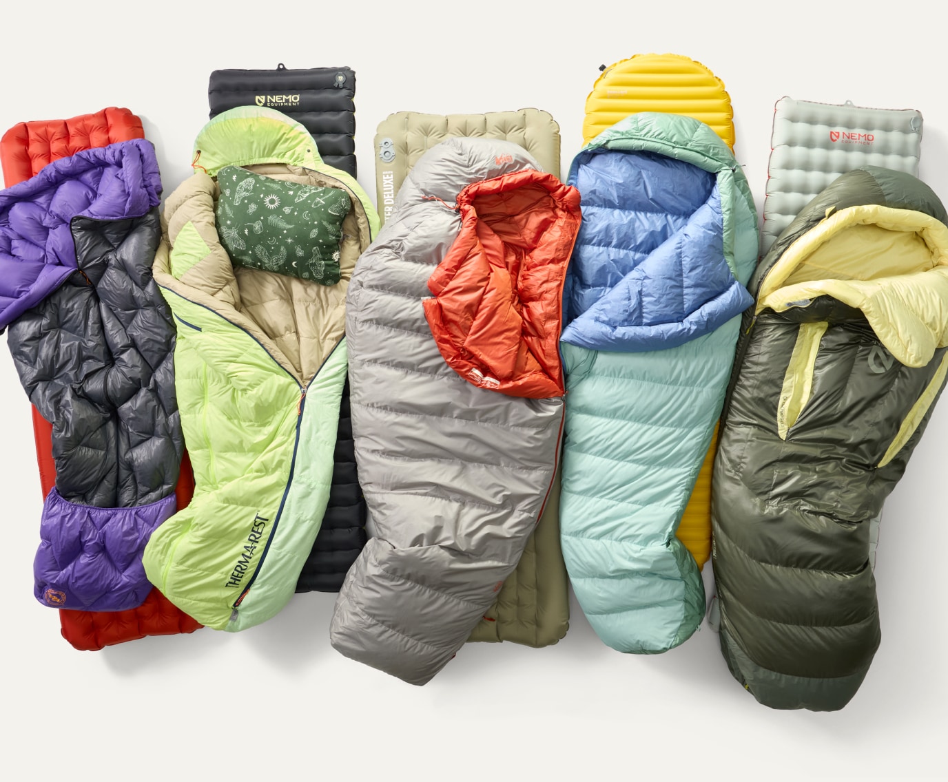A collage of sleeping bags & pads from Big Agnes, NEMO, & R E I Co-op.