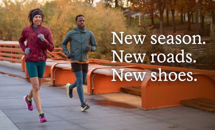 Two pals running on a paved path. Headline: New season. New roads. New shoes.