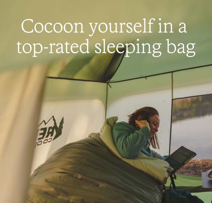 Person in tent reads a book. Headline: Cocoon yourself in a top-rated sleeping bag