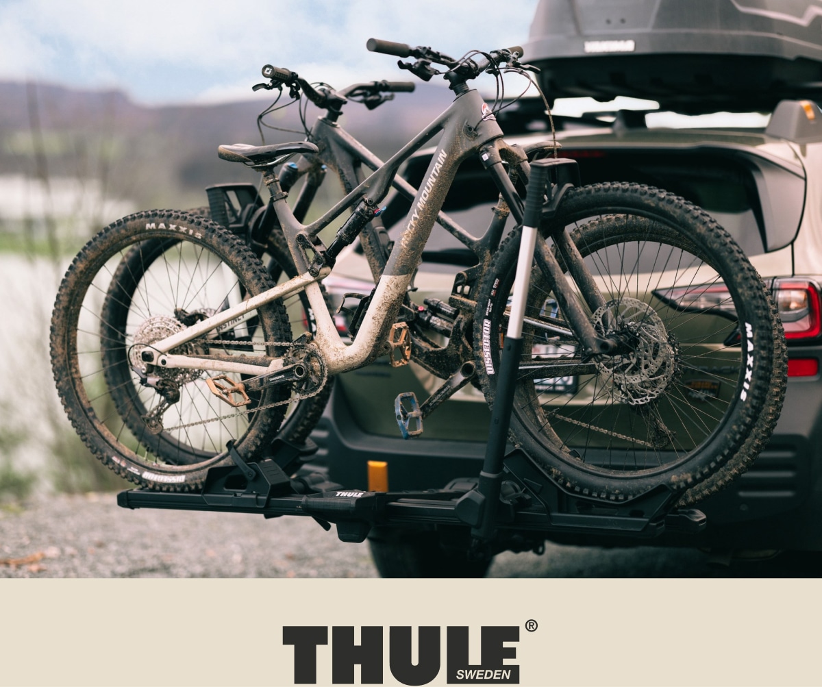 A bike rack with two bikes attached to a car.