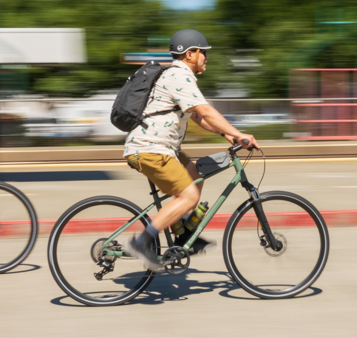 A person rides down a paved road on their Co-op Cycles CTY 2.1 bike.