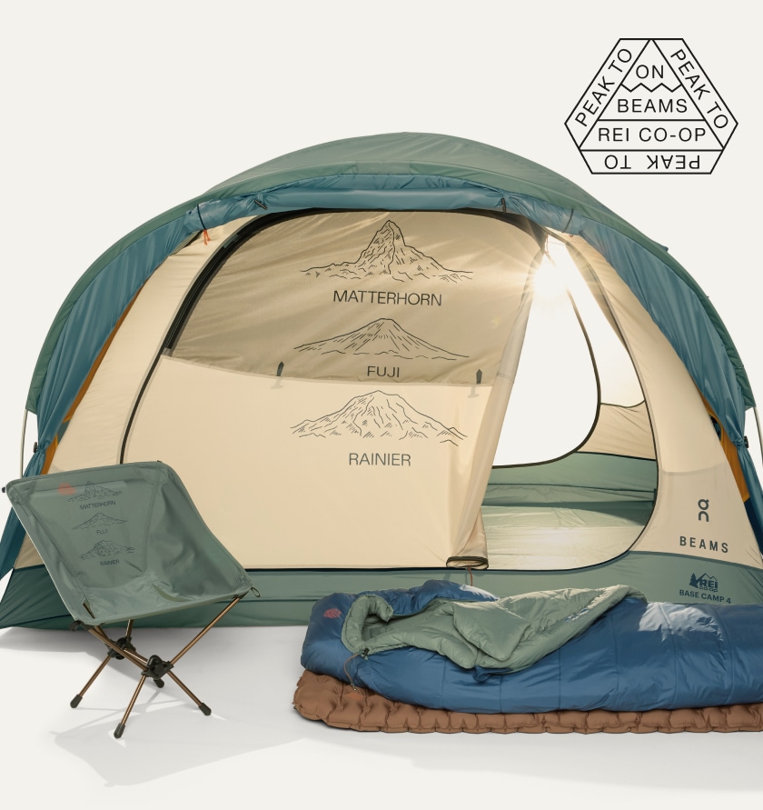 A tent, chair, sleeping bag and sleeping pad on a light colored background.
