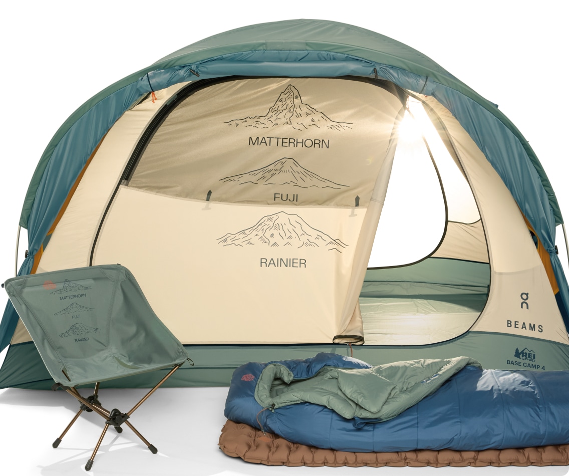 A tent, chair, sleeping bag and sleeping pad on a light colored background.