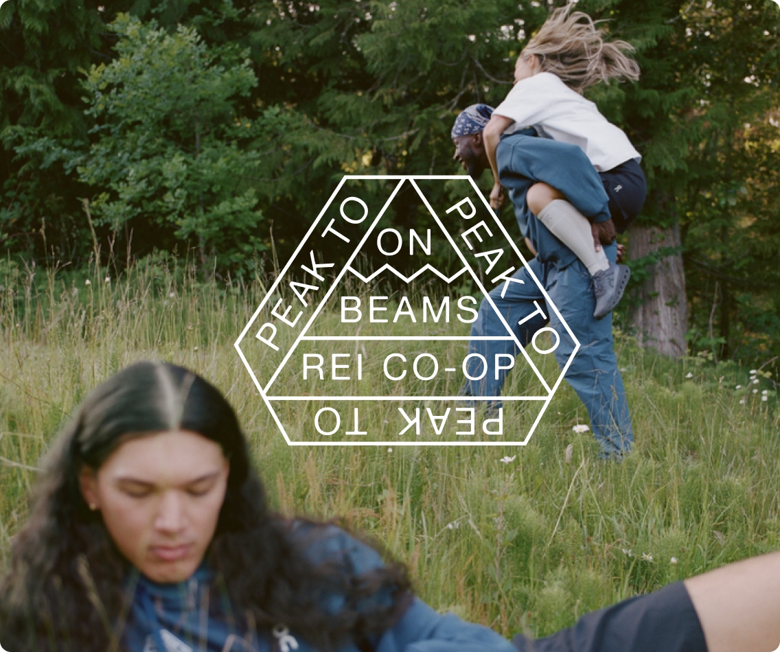 A logo over an image of 3 people in a field.
