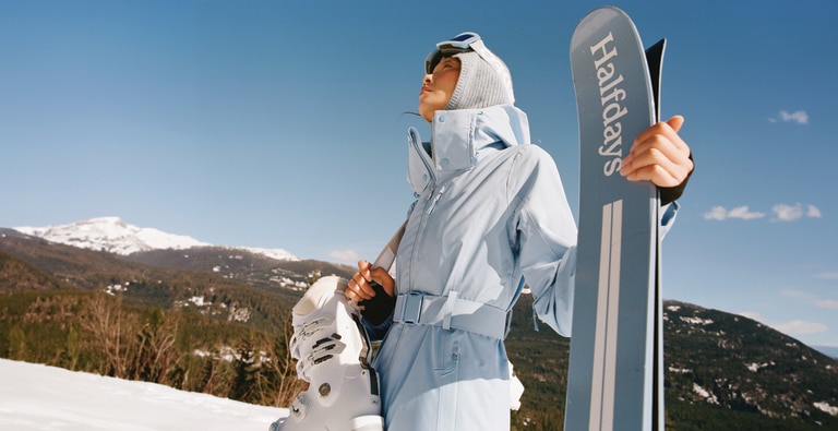 A person wears a light blue Halfdays jacket