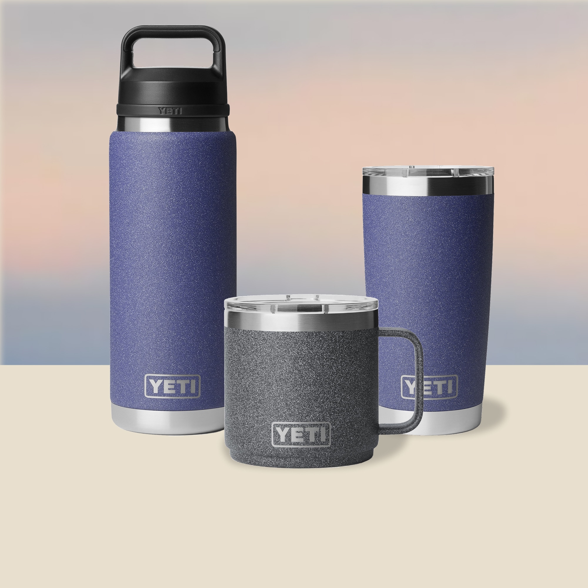 YETI. YETI drinkware in new seasonal colors, Moon Dust and Black Stone, over a gradient background.