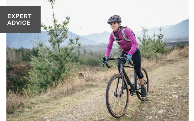 A woman rides a gravel bike down a dirt path. Headline: EXPERT ADVICE
