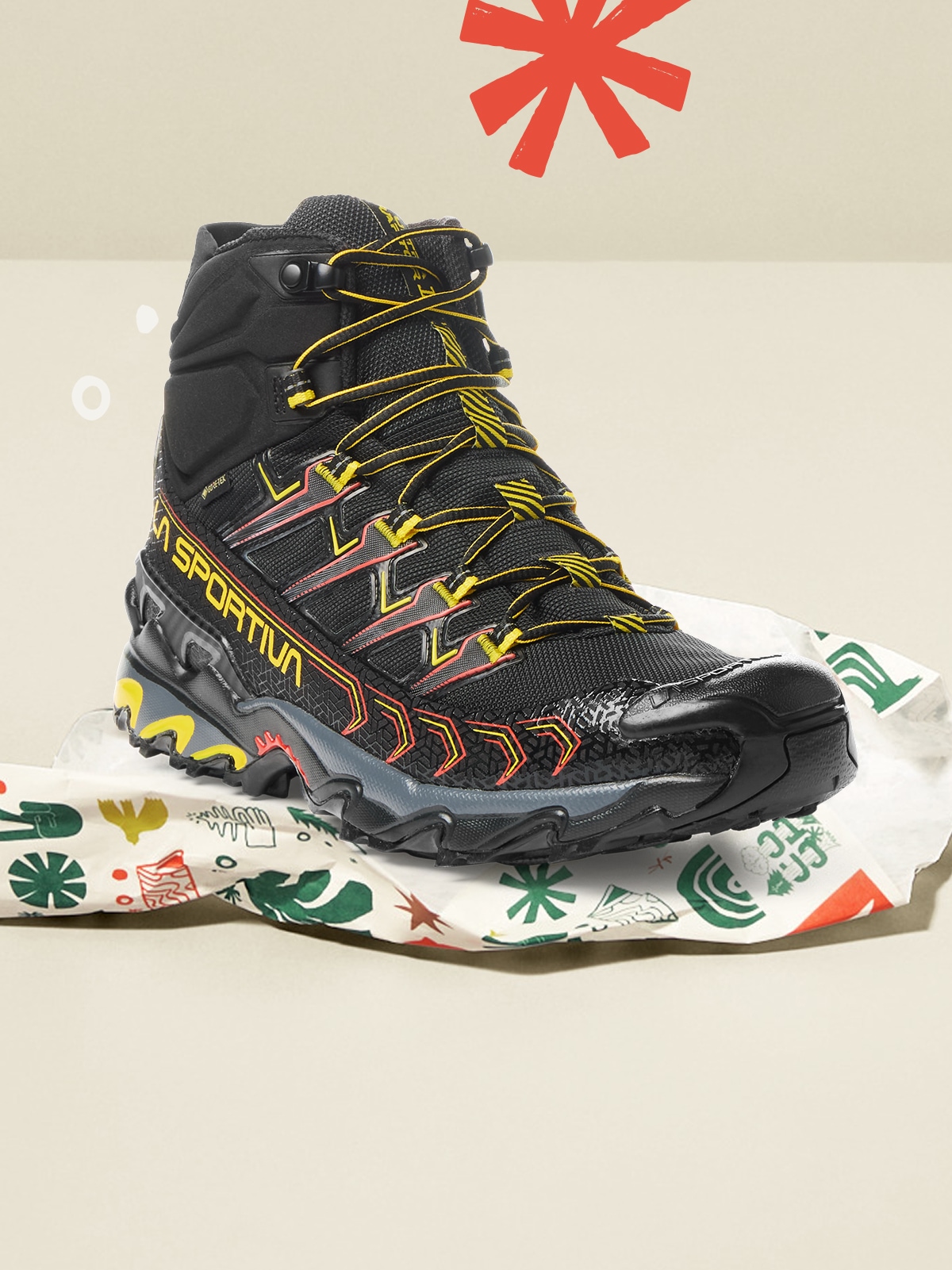 A La Sportiva shoe sitting on top of holiday wrapping paper.