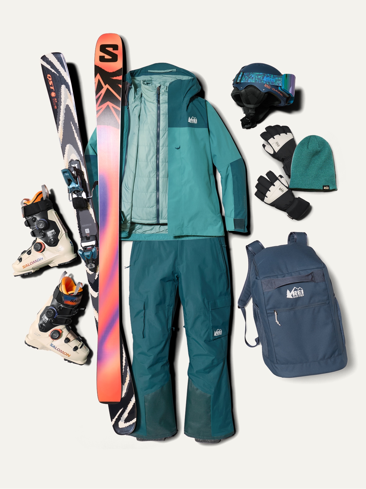 A collage of ski clothing and gear over a light colored background.