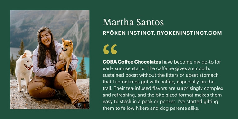A person with two dogs is sitting in front of a mountain landscape, smiling at the camera. To her right is copy that says Martha Santos, Ryoken Instinct, and a gifting recommendation to buy COBA Coffee Chocolates for the holidays.