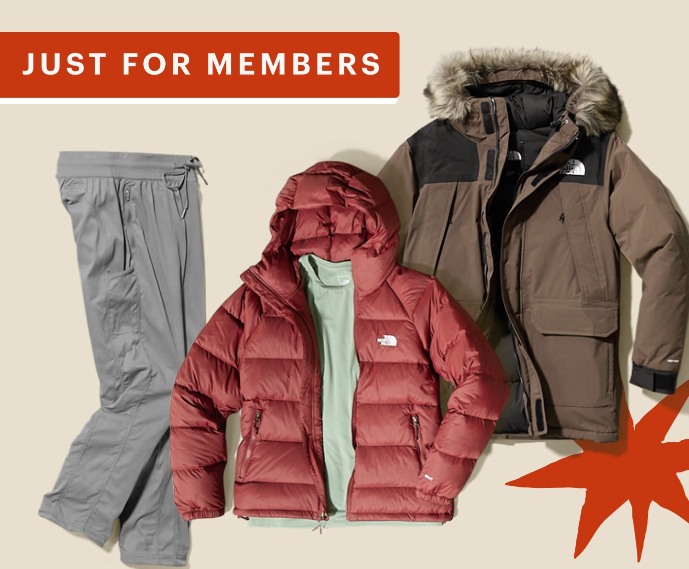 Two jackets and a pair of pants from The North Face on a light colored background.