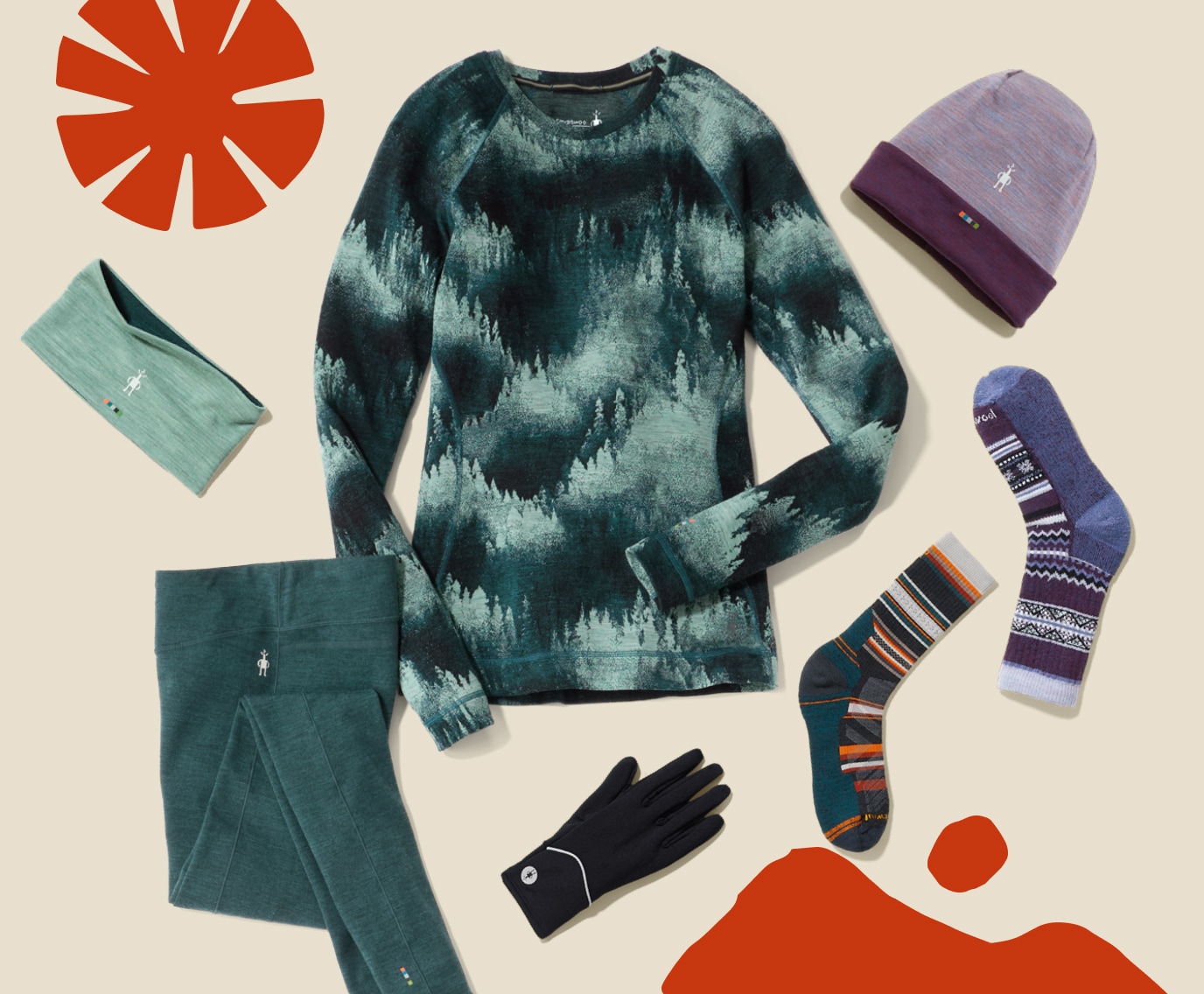 Base layers, socks, gloves, & hats from Smartwool on a light colored background.