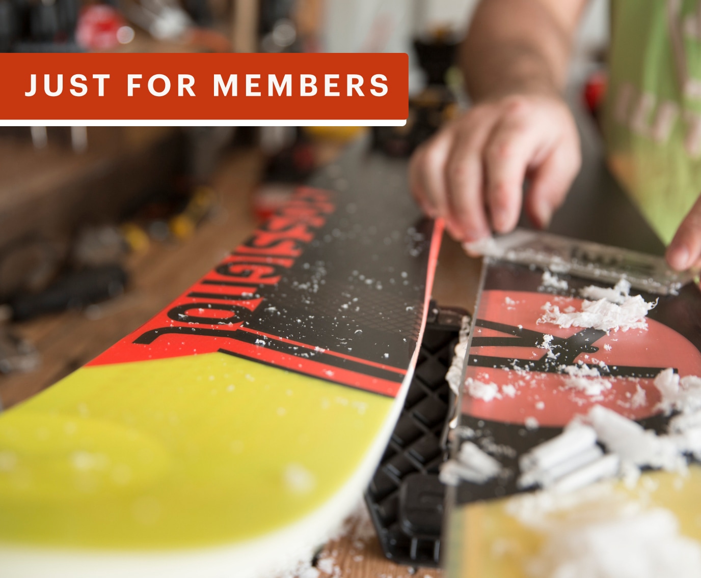 A person waxes a pair of skis.