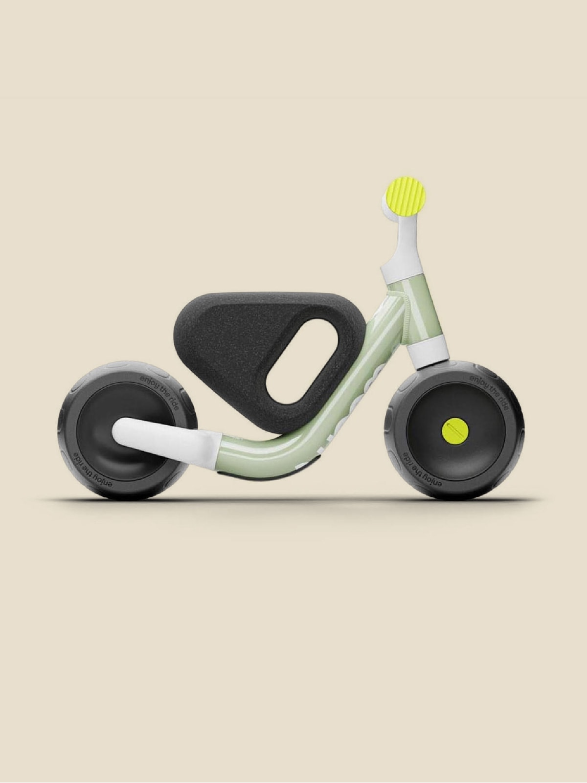 A Woom kids bike on a light colored background.