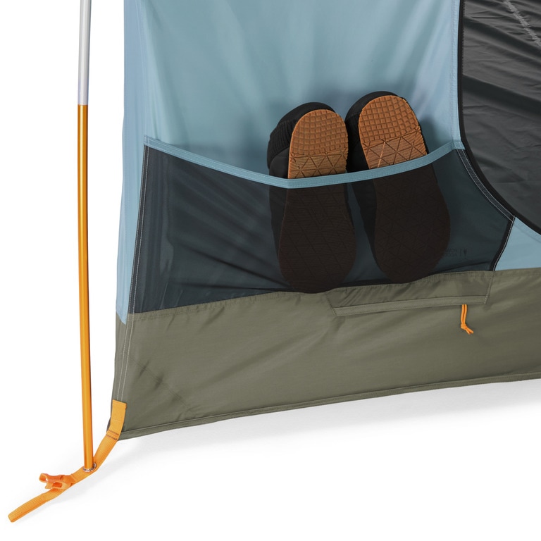 Picture of a pair of camp shoes on the exterior of the blue REI Co-op Westward tent