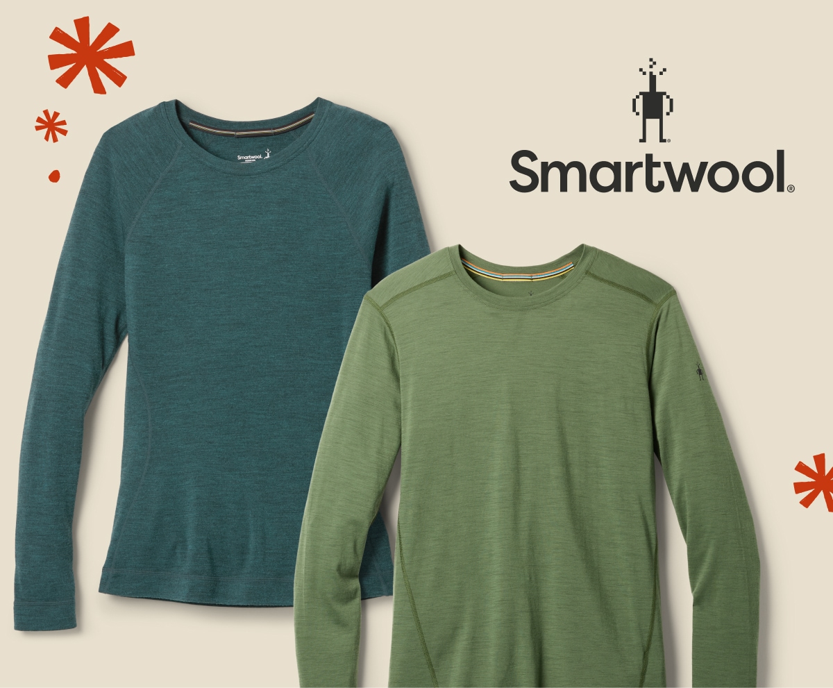 Two base layer tops from Smartwool over a light colored background.