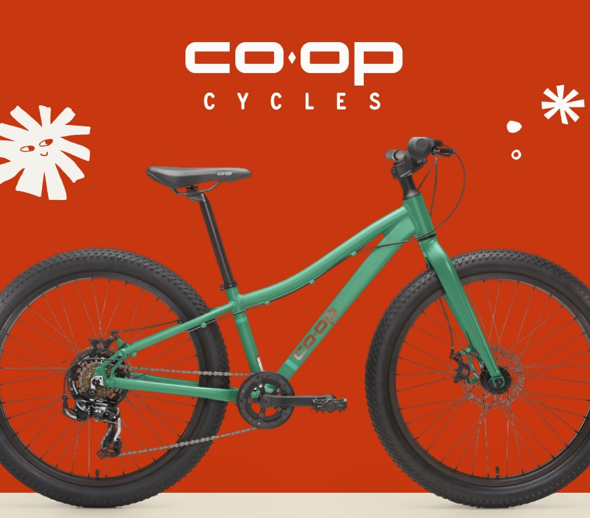 A green Co-op Cycles bike over a red background.