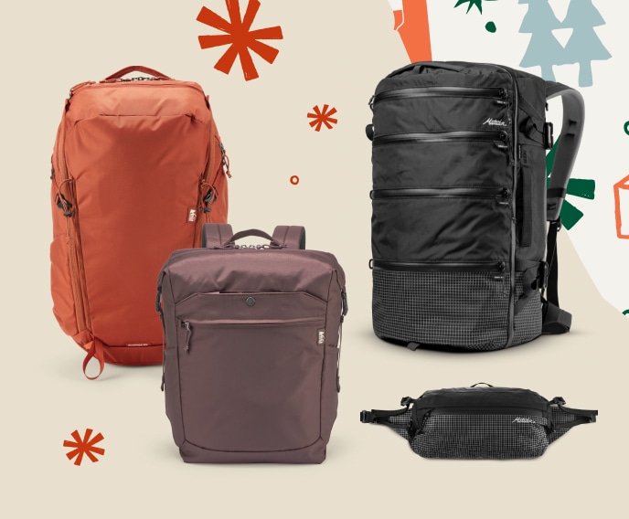 A collage of various travel bags on a light colored background snowflakes and holiday wrapping paper in the corner.