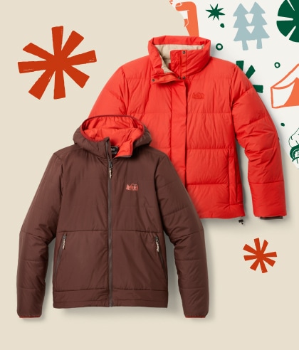 Two R E I Co-op brand jackets on a light colored background with snowflakes.