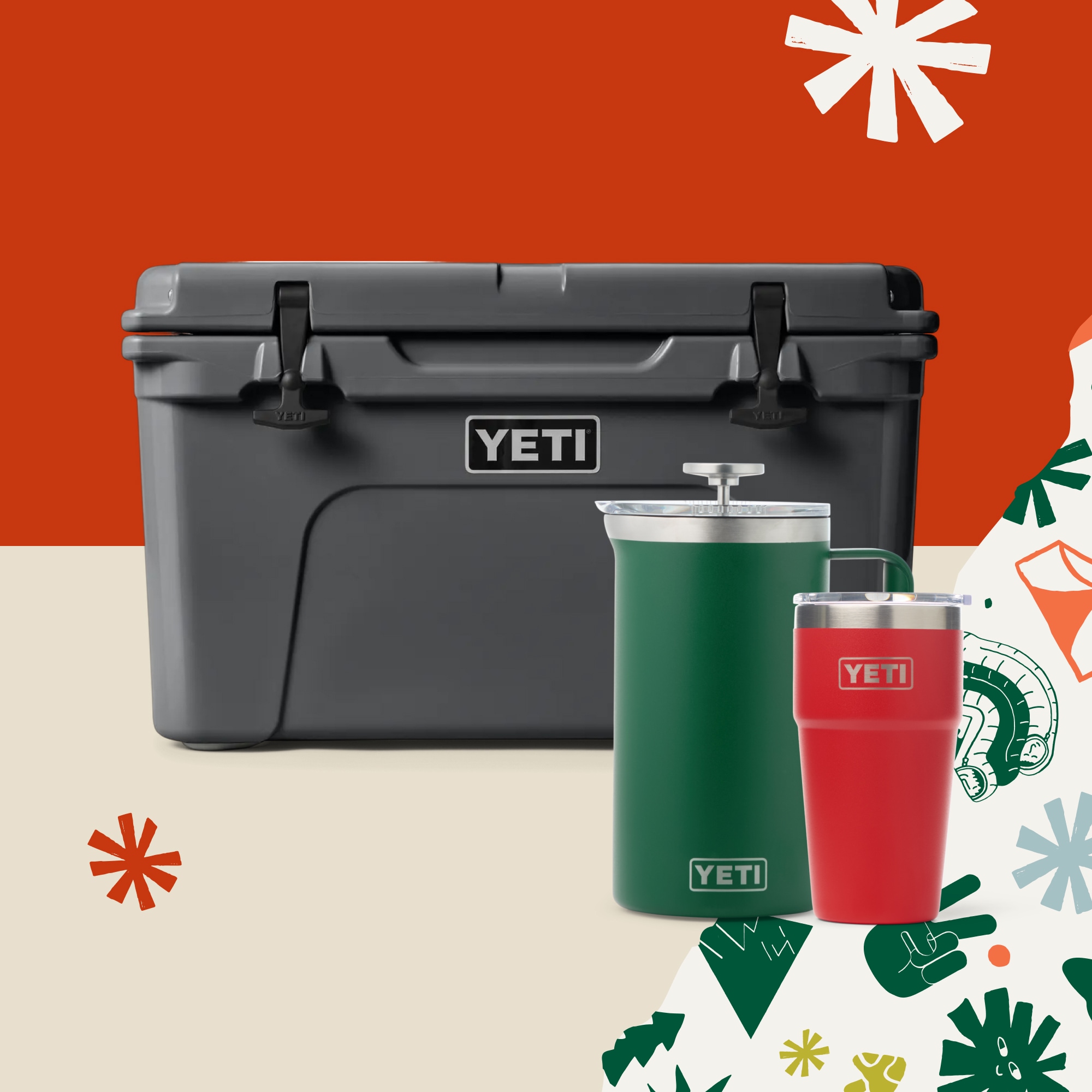 A YETI cooler, french press, and stackable cup with holiday gift wrap and snowflakes in the background.