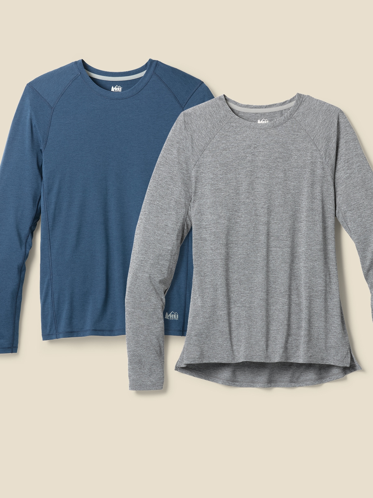 Two R E I Co-op brand long-sleeve running tops on a light colored background.