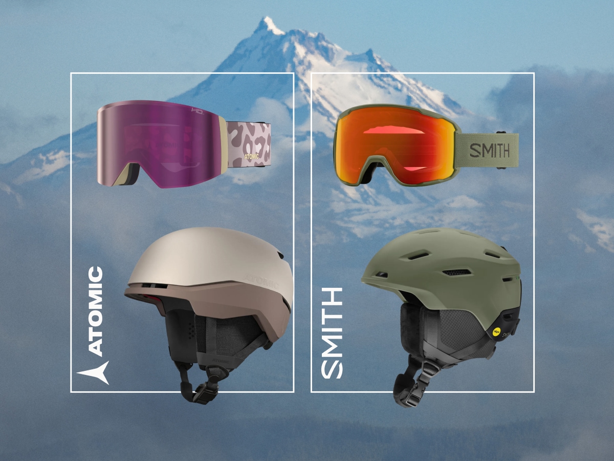 Snow helmets and goggles from Atomic and Smith over an image of snow covered mountains.