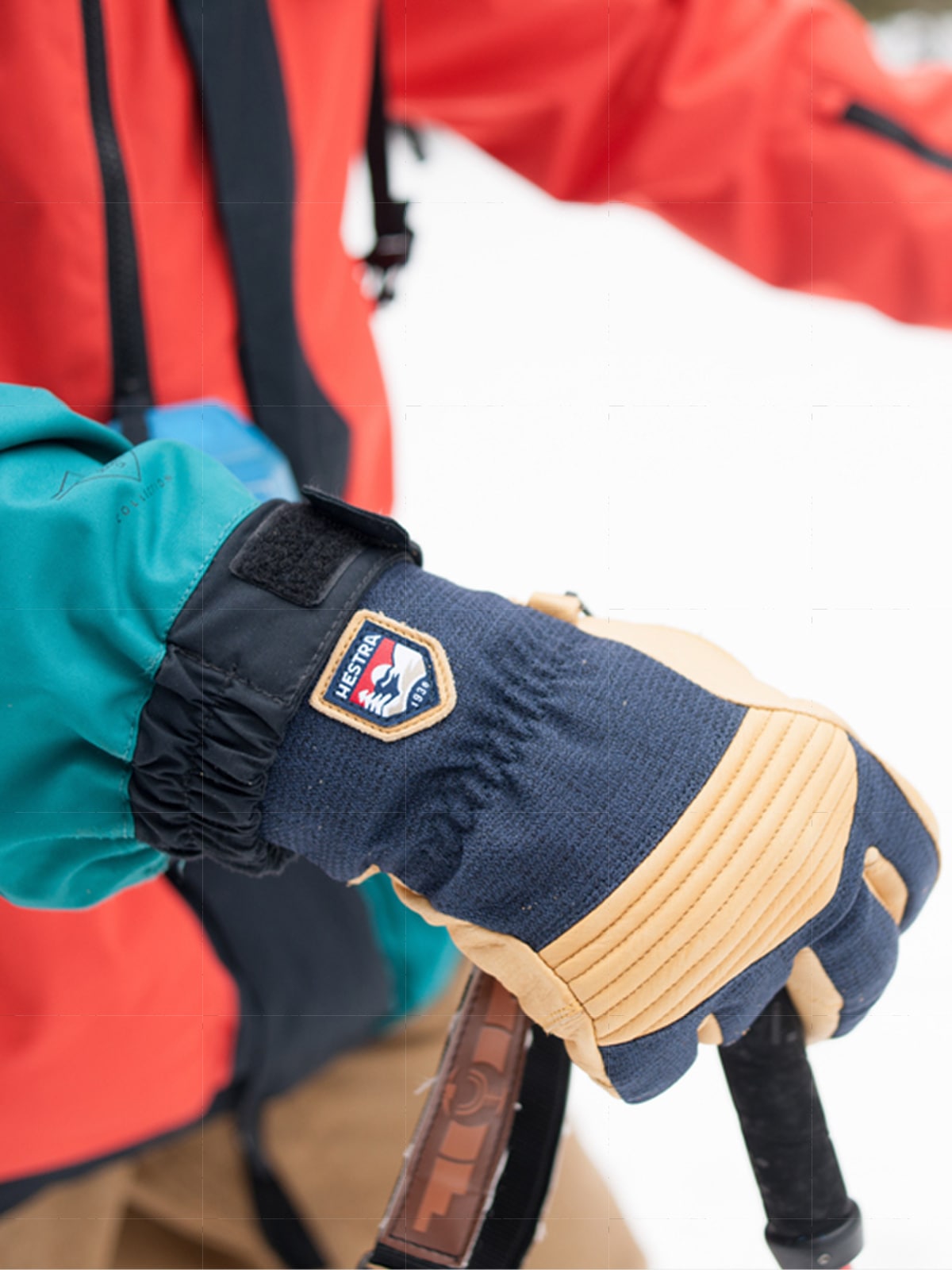 A person wearing Hestra gloves on a snowy day.