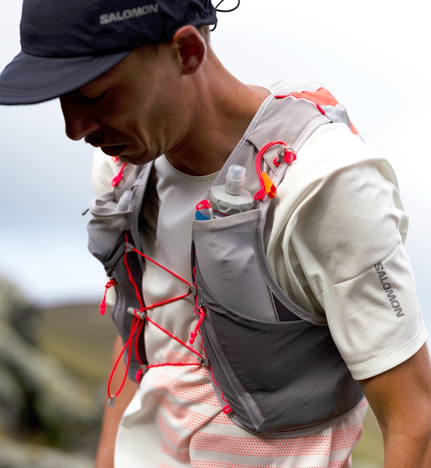 A person wearing the Salomon Adv Skin 12 hydration vest.
