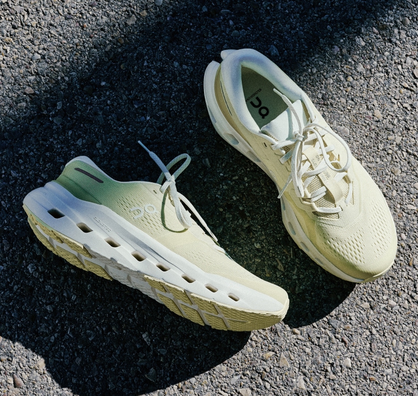 A pair of On Cloudrunner 3 shoes photographed on a paved road.