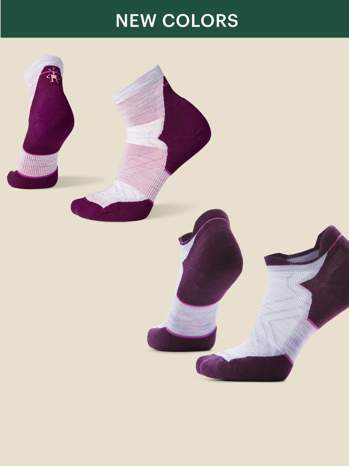 Two pairs of Smartwool socks in new colors on a light colored background.