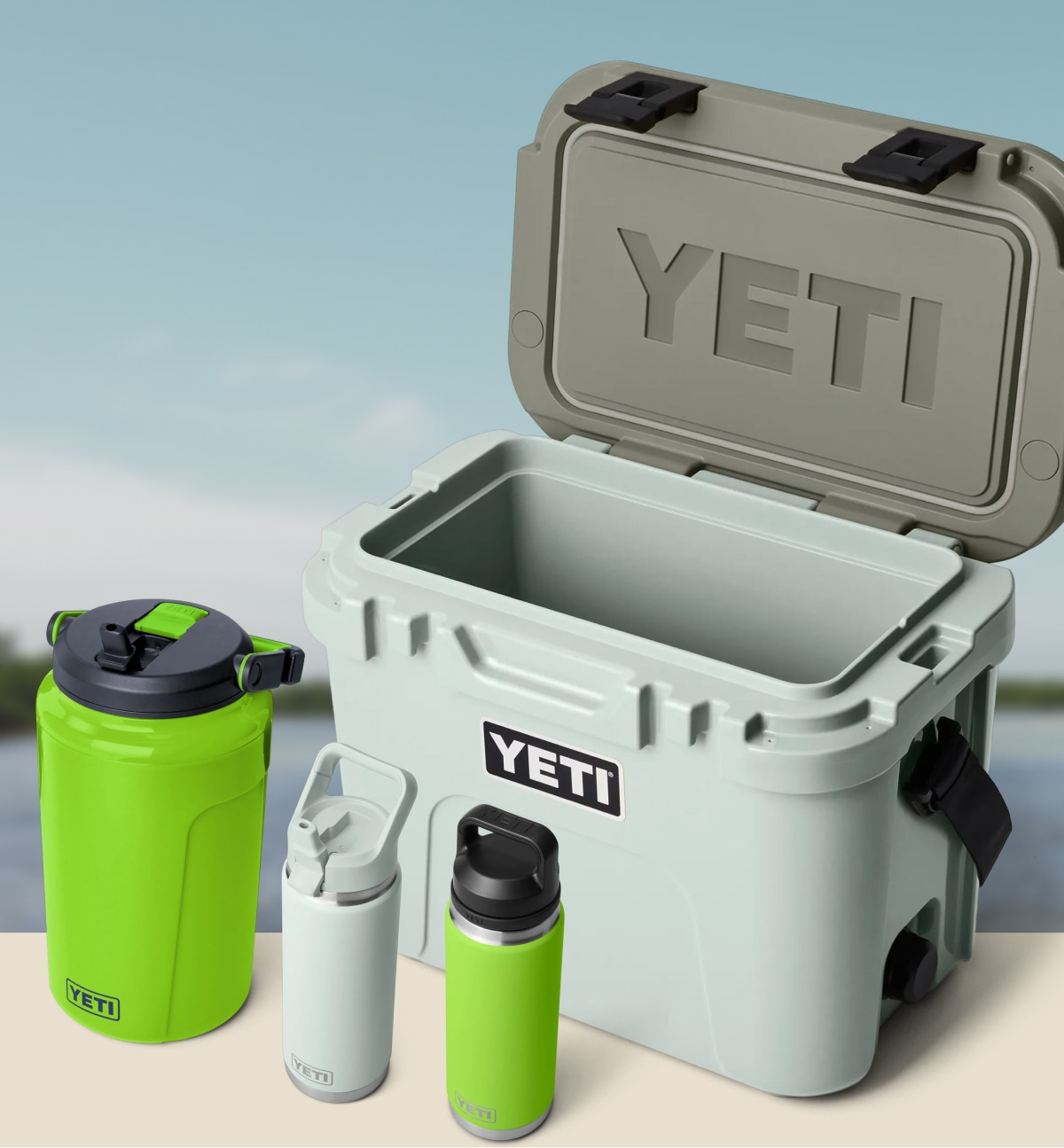 A YETI cooler and drinkware over an image of a lake.