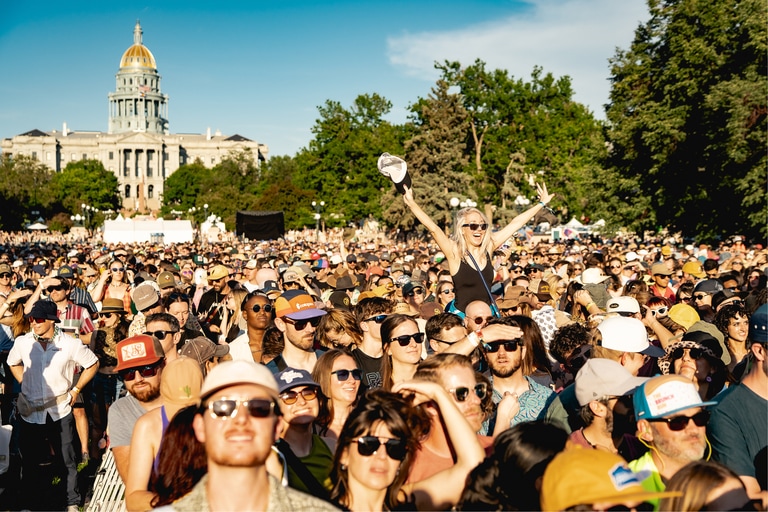 View of a crowd at an outdoor concert on a sunny day