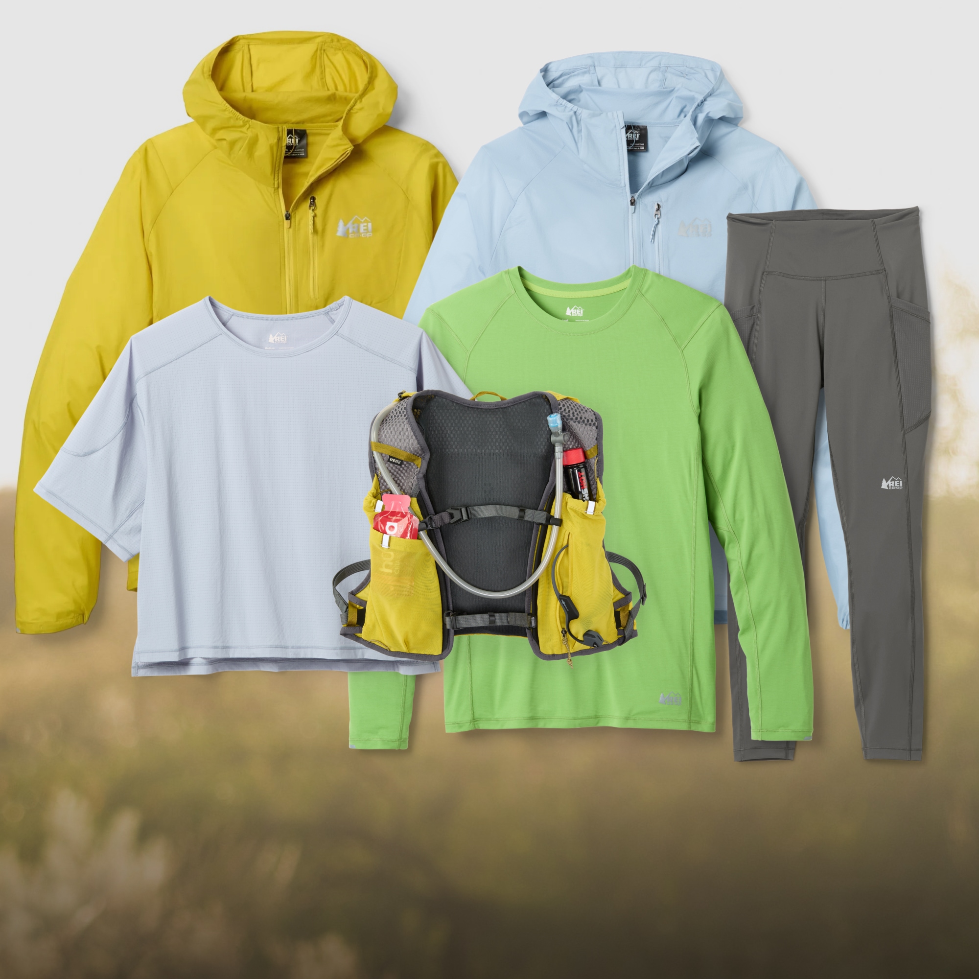 A collage of Swiftland running clothing and gear over an image of grass.