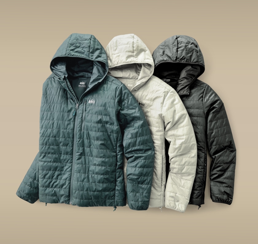 Three R E I Co-op Microtrek jackets on a light colored background.