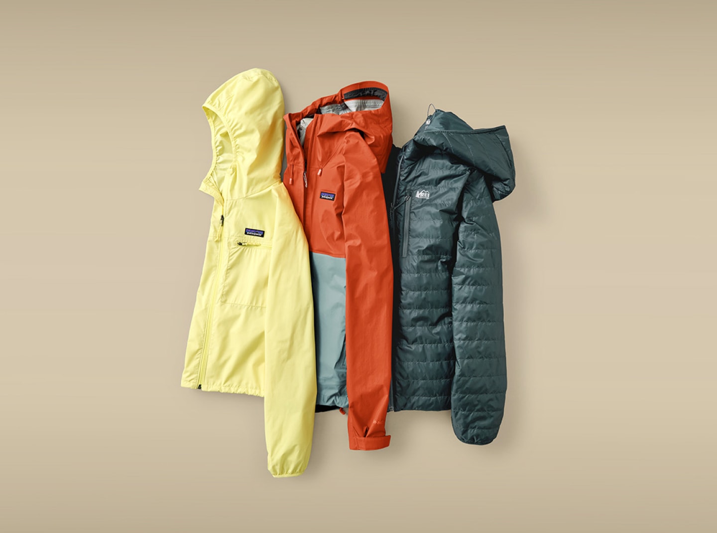 Two Patagonia jackets and an R E I Co-op brand jacket on a light colored background.