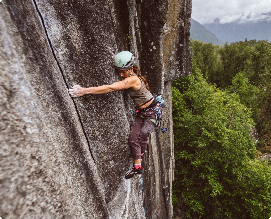 A climber ascends a steep rock face.