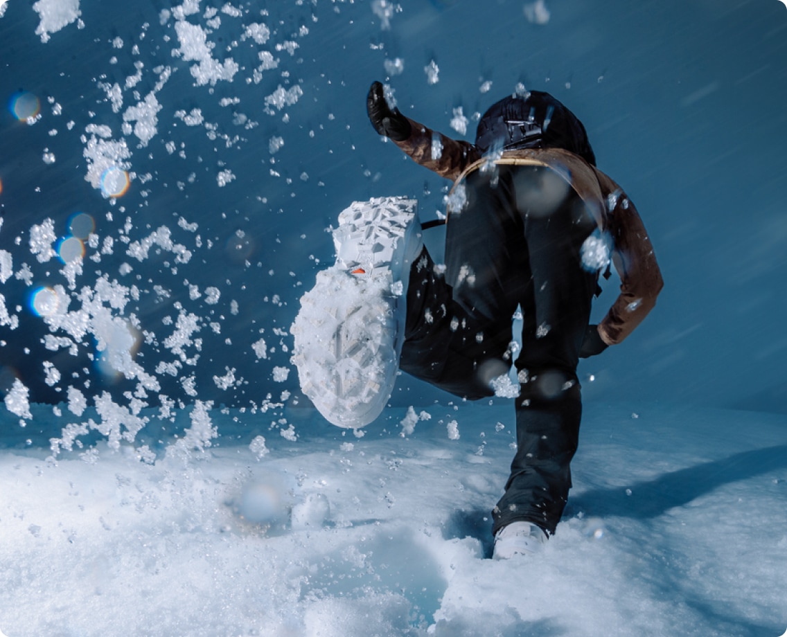 A person treks through the snow in their Salomon snow gear.