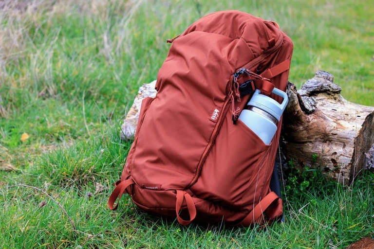 The YETI Rambler water bottle is stuff into the side pocket of a backpack for hiking