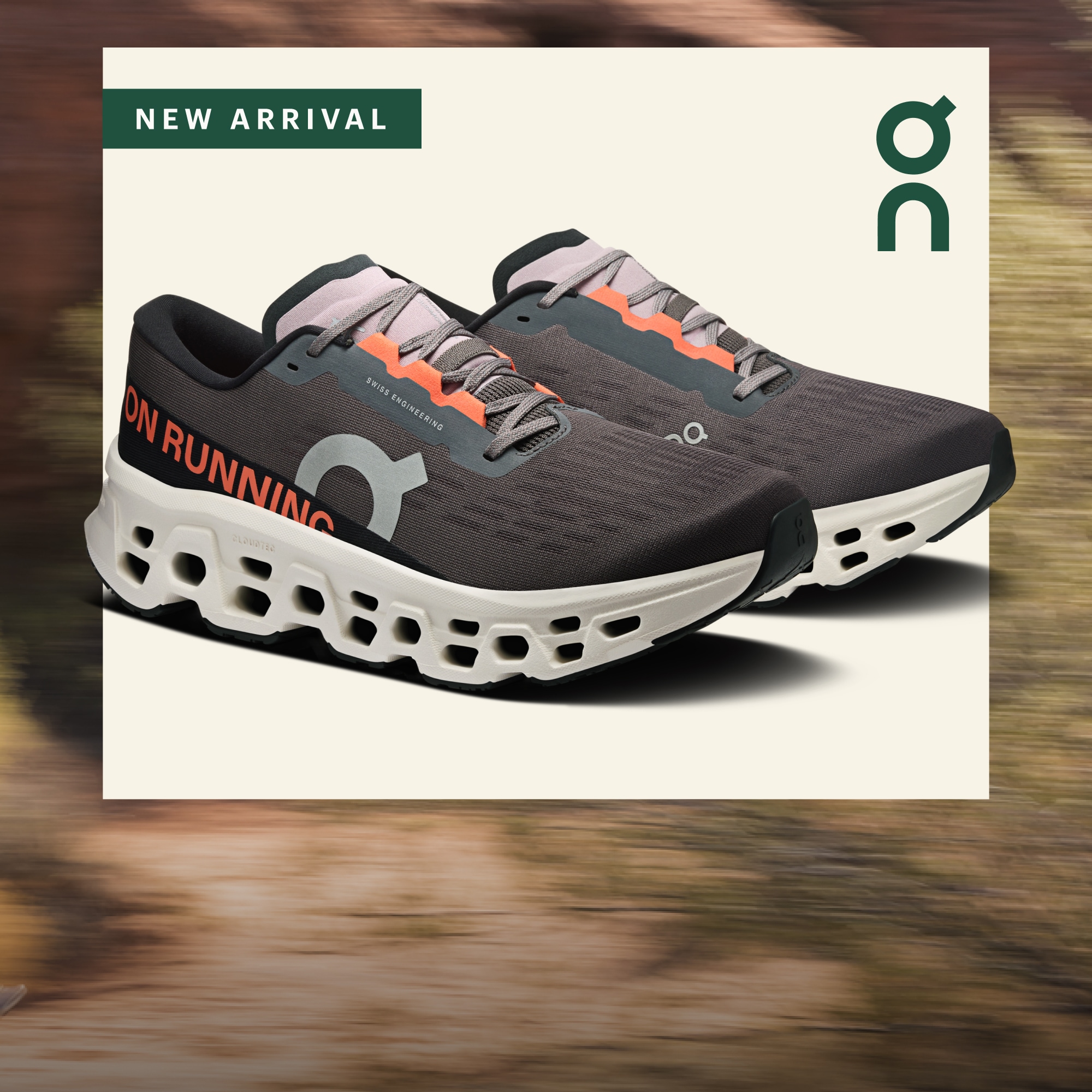 New arrival. A pair of On Cloudmonster 3 shoes on a light colored background over a blurred image.