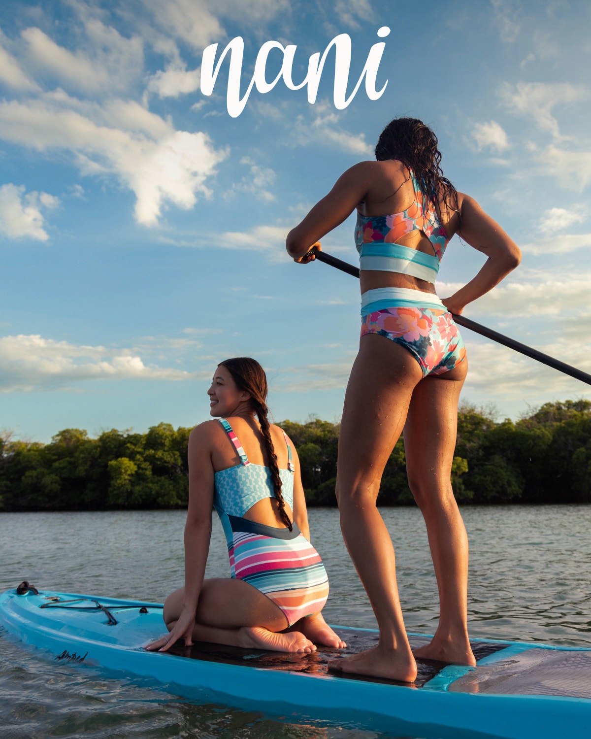 Two people paddle out on a kayak in their Nani swimsuits.