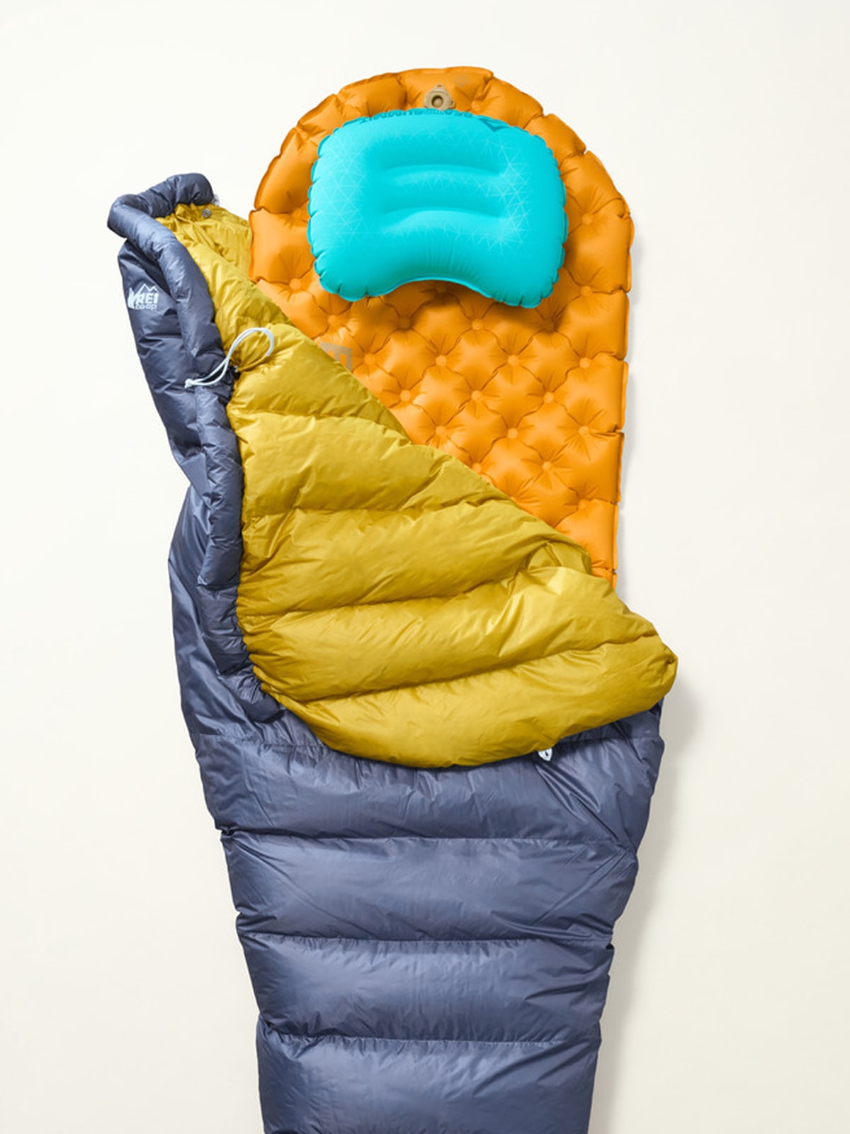 A person finishes inflating their sleeping pad.