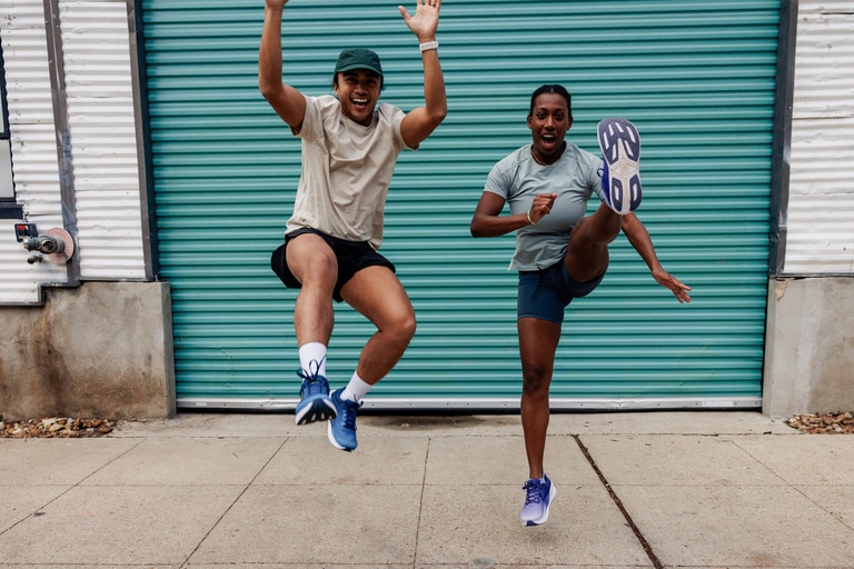 Two runners jumping and kicking their legs