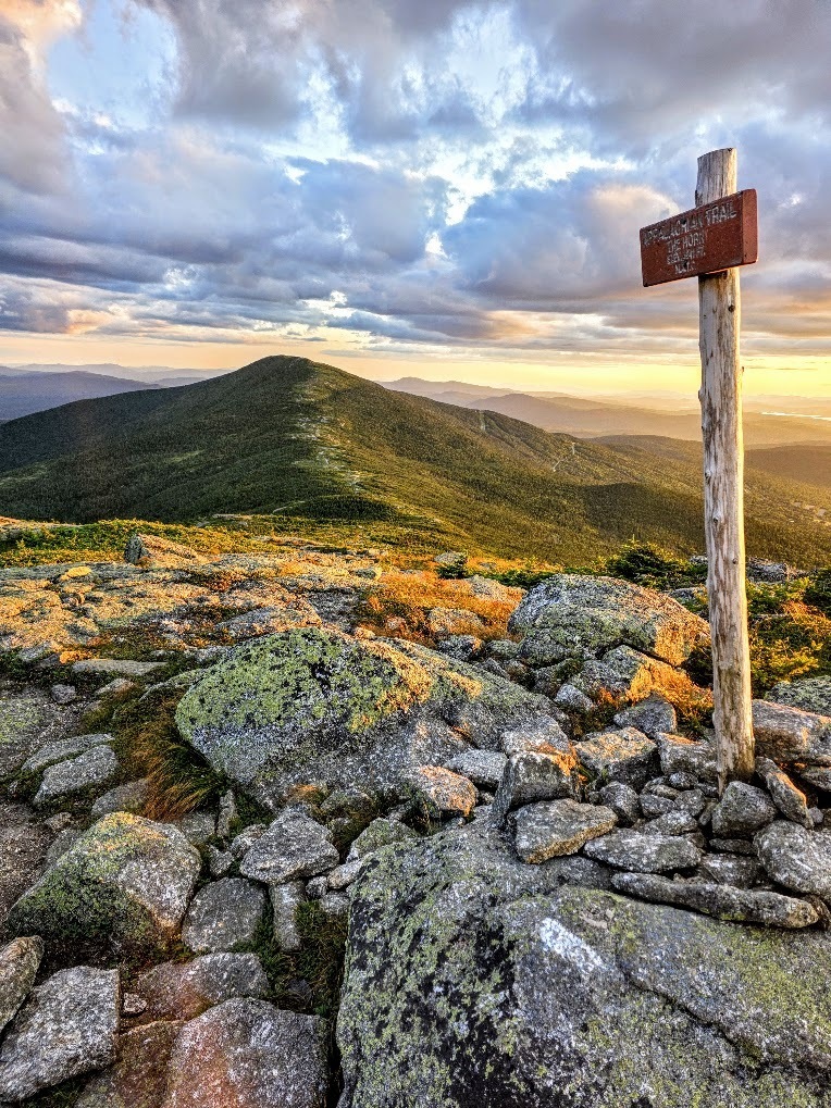 A trailhead on the Appalachian Trail in the foreground and a mountain in the background