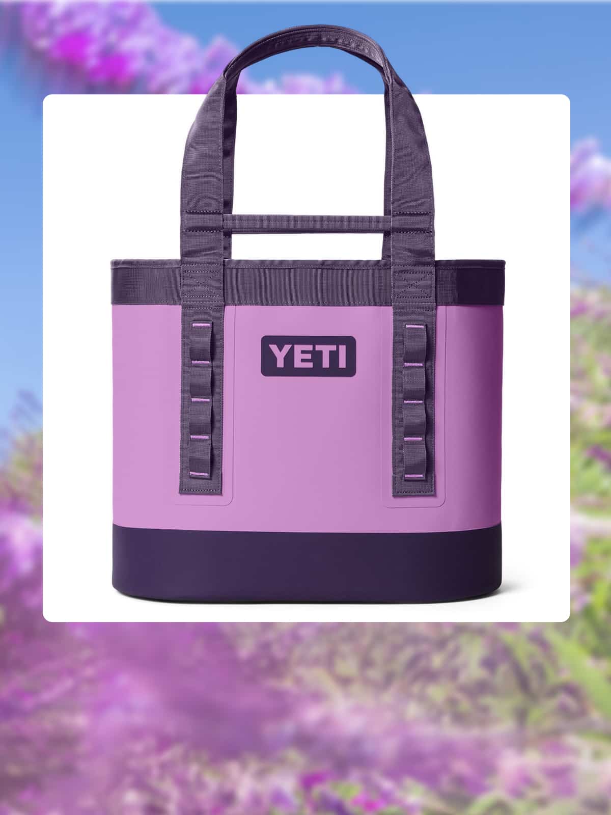 A YETI carryall bag on a white background over an image of purple flowers and green leaves.